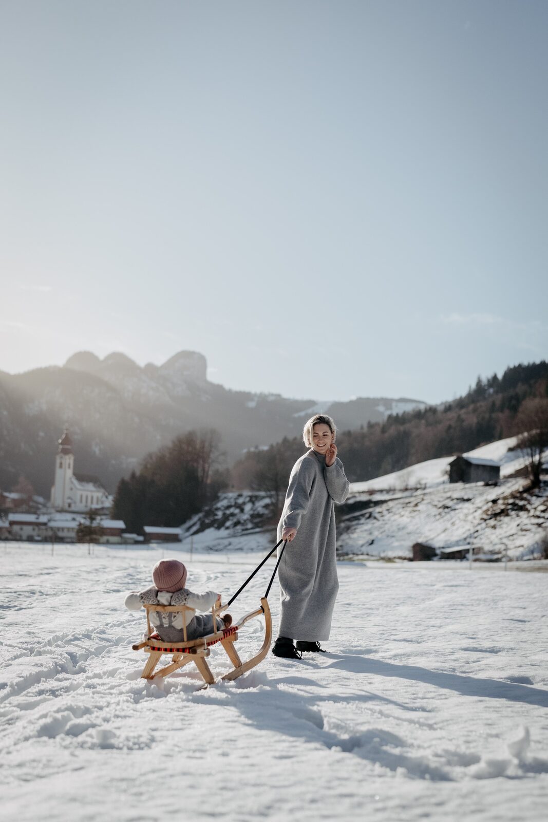 Children on a sledge in the snow between runs.